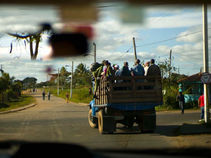 Meanwhile, tobacco farmers in Cuba pile on to a truck bed to head to work.