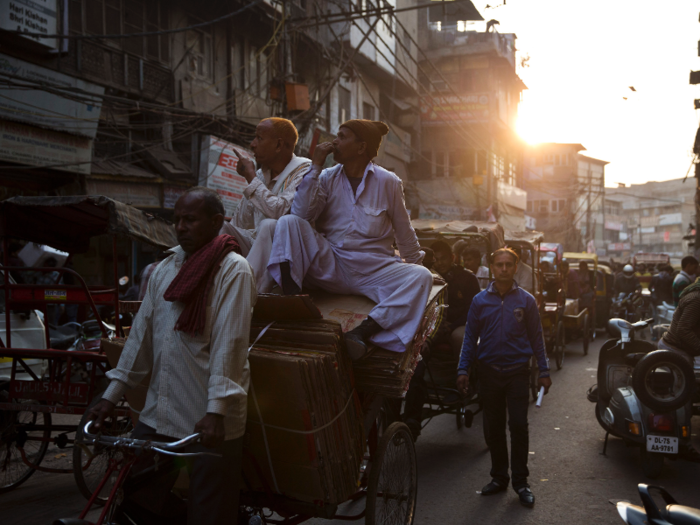 In New Delhi, commuters hail rickshaws.