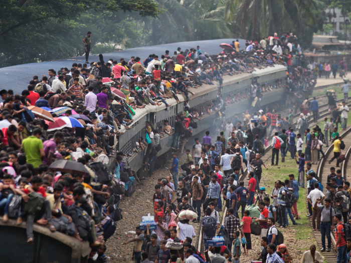 The trains in Bangladesh are some of the most crowded for commuters, many of whom risk riding on the roof or hang onto the sides.