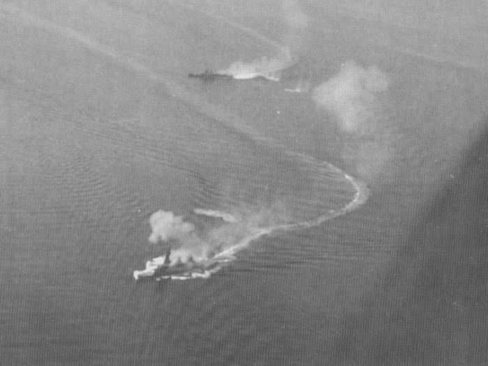 Two Japanese battleships, the Fusō (front) and possibly the Yamashiro (back), under attack from US planes. Both battleships were sunk during the engagement.