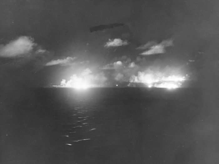 The cruisers USS Louisville, USS Portland, USS Minneapolis, USS Denver, and USS Columbia fire simultaneously on Japanese ships.