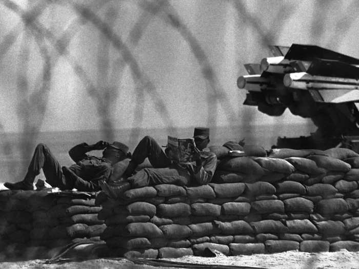 Soldiers manning Army installations on the barricaded beach may look relaxed to the tourists driving along the road, but they are on the alert for anything that comes along in Key West, November 5, 1962.