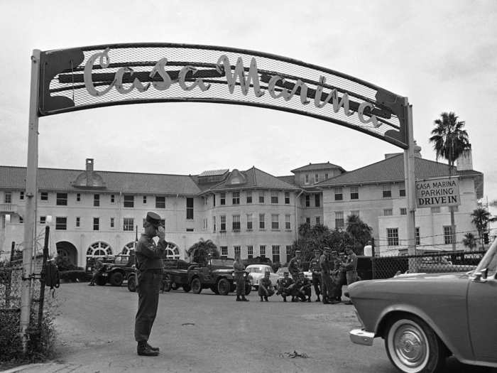 A sentry salutes an incoming car at the gate of the Casa Marina resort hotel in Key West, Florida, which is occupied by US troops who moved into the city, October 26, 1962. During World War II the hotel was used to billet Navy officers.