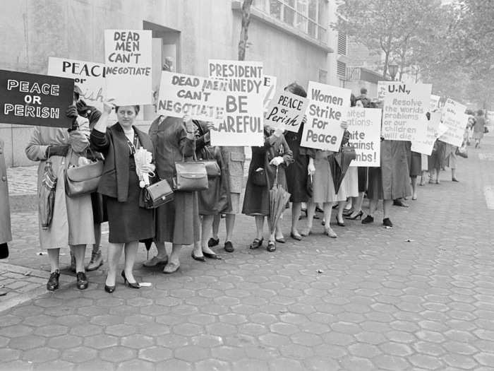 Pickets representing an organization known as Women Strike for Peace carry placards outside UN headquarters in New York City, October 23, 1962.