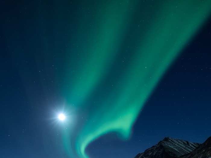 Beyond those 11 prize-winning photos, the contest also honored runners-up as well as "highly commendable" images, like this shot. The image shows an aurora and the moon as seen from a chilly archipelago.