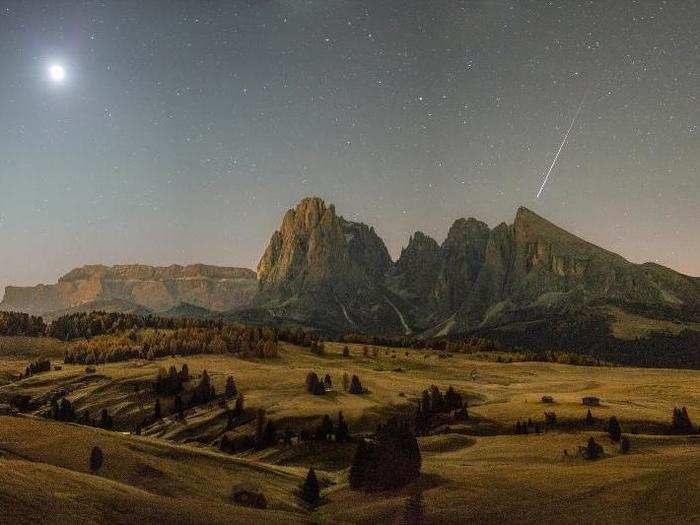 A 15-year-old took this image just before dawn. The moon is at top-left and a shooting star at the right. "With a painterly style and beautiful composition, this photograph has a quality that is beyond the years of the photographer," one judge said.