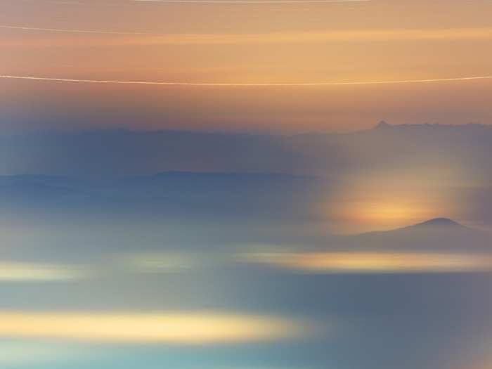 This dreamy, pastel-infused image blends together a series of photos of the same region of sky, taken over half a winter season. Cities glow below, and the semi-circular streak at the top is the circumpolar star Almach.