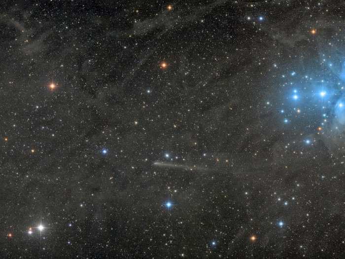 The green comet C/2017 O1 (left) and the white comet C2015 ER61 (center) seem to sail away from the Pleiades star cluster (right) in this winning picture.