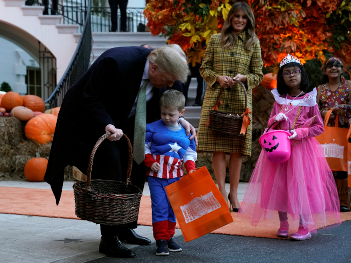 Kids dressed as superheroes, dinosaurs, and vampires for the trick-or-treating event.