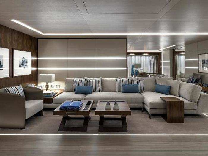 The yacht features sleek wood-paneling and slim lights built into the floors, walls, and ceilings.