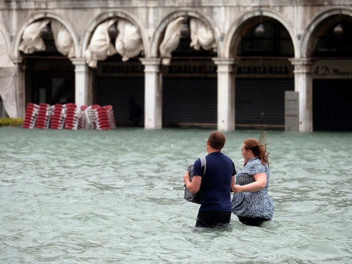 Shop owners tried to keep the water out of their stores through pumps and metal or wooden barriers.