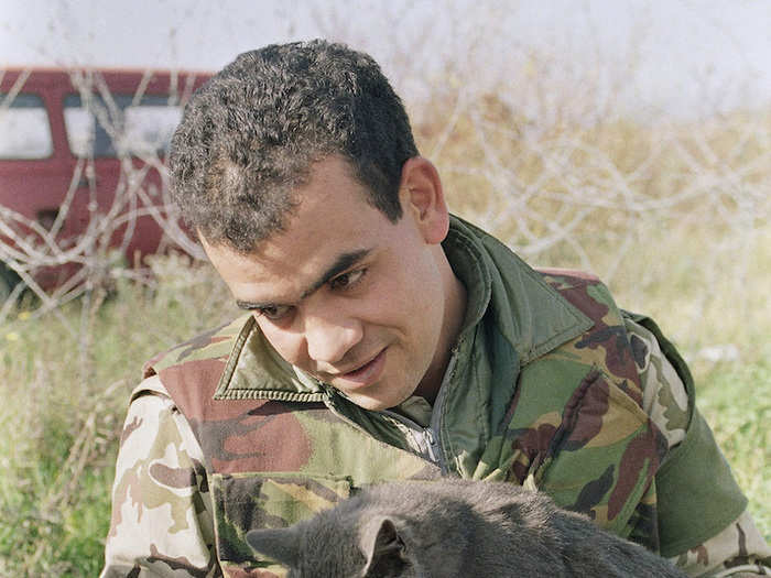 Egyptian in the UN protection force in Bosnia feeds yogurt to an abandoned cat in 1992.