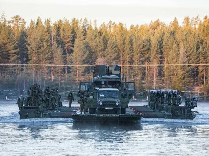 Norwegian and German military personnel transport PATRIOT surface to air missile systems across a river in Norway on Oct. 24, 2018 during exercise Trident Juncture 18.