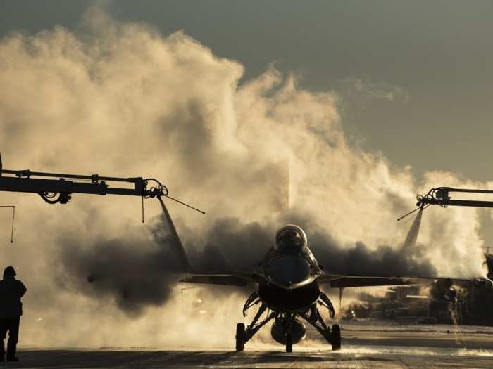 A US Air Force F-16 Fighting Falcon assigned to the 480th Expeditionary Fighter Squadron is de-iced during Exercise Trident Juncture 18 at Kallax Air Base, Sweden, Oct. 29, 2018.