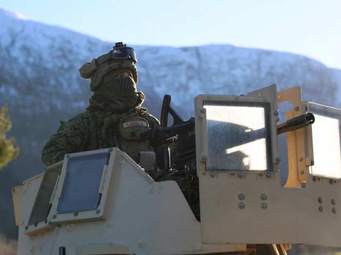 A US Marine with 24th Marine Expeditionary Unit await commands atop a High Mobility Multipurpose Wheeled Vehicle during Exercise Trident Juncture 18 in Alvund, Norway, Oct. 29, 2018.