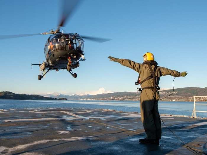 Belgium Air Force Helicopter Alouette III takes off from mother ship BNS Godetia for a tactical flight over the fjords in support of the Amphibious Livex of Trident Juncture.