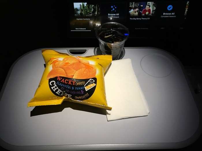 Soon, it was time to settle in for another nap and some quality TV time. Around hour 13, flight attendants came around with another round of snacks. This time, it was a diet coke and a bag of cheesy chips.