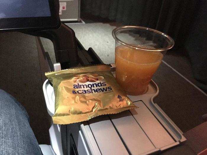 Shortly after takeoff, service opened with a glass of orange juice and a bag of mixed nuts.