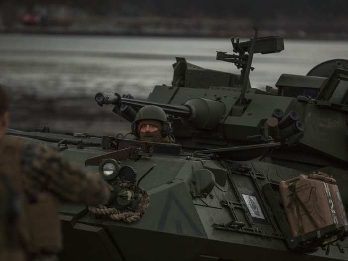 Marines come ashore in armored assault vehicles after disembarking from the landing craft.