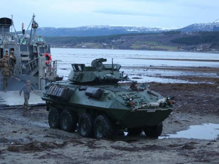 Marines with 2nd Assault Amphibian Battalion, 2nd Marine Division offload light armored vehicles from a landing craft.