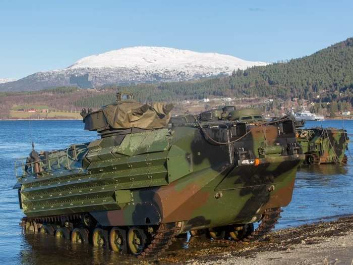 The amphibious assault vehicles come ashore.