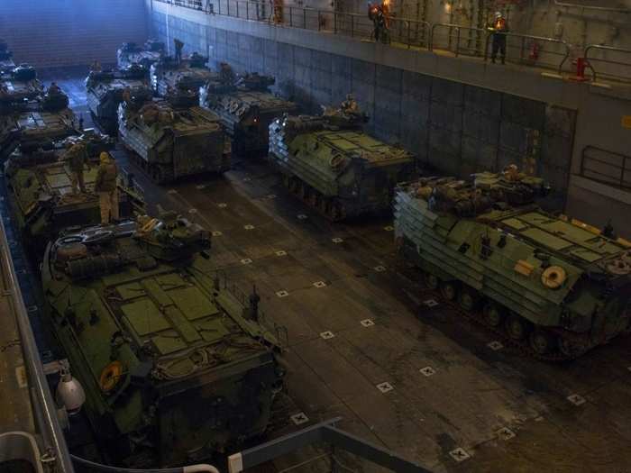 Amphibious assault vehicles assigned to the 24th Marine Expeditionary Unit prepare to leave the well deck of the USS New York.