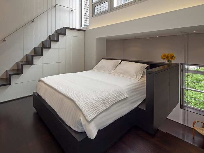 The stairwell features built-in drawers and shelves, which provide extra storage.