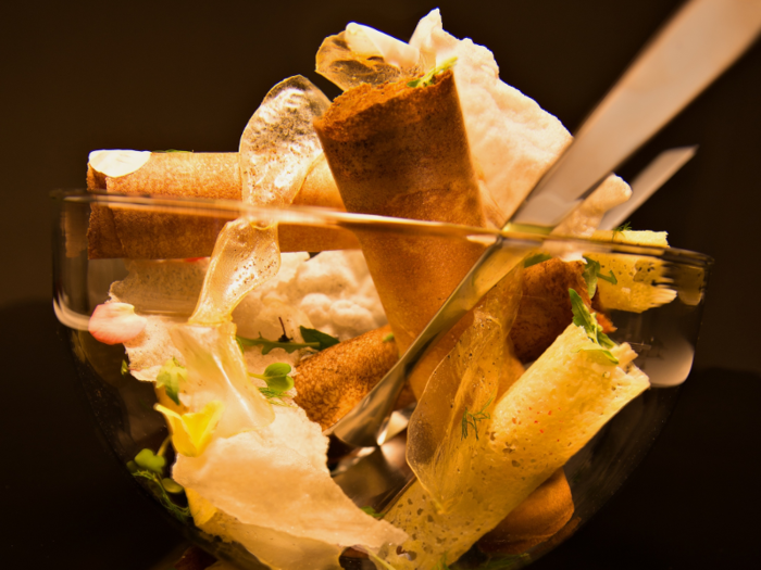 This "crunchy fierce salad" includes crisps of rice, a bread roll, cheese and potato, mushroom, arugula, and turnip.