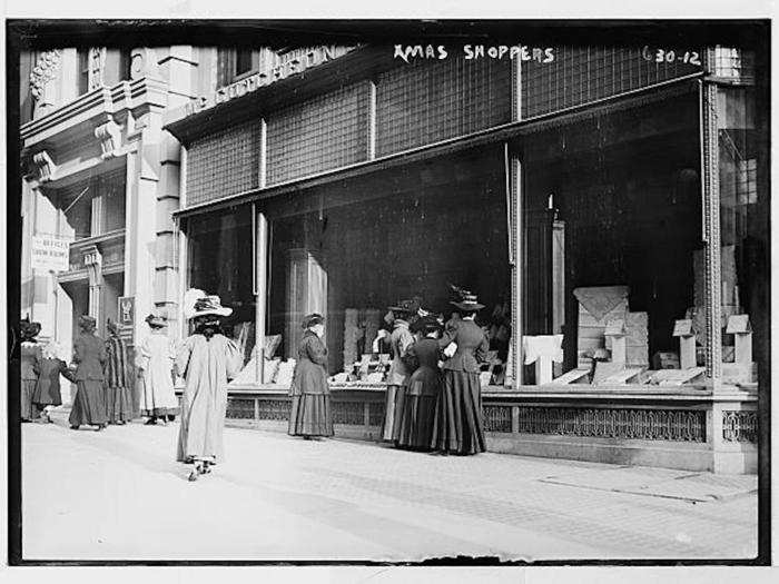 This 1933 photo shows shoppers in New York City, admiring the window displays of a department store.