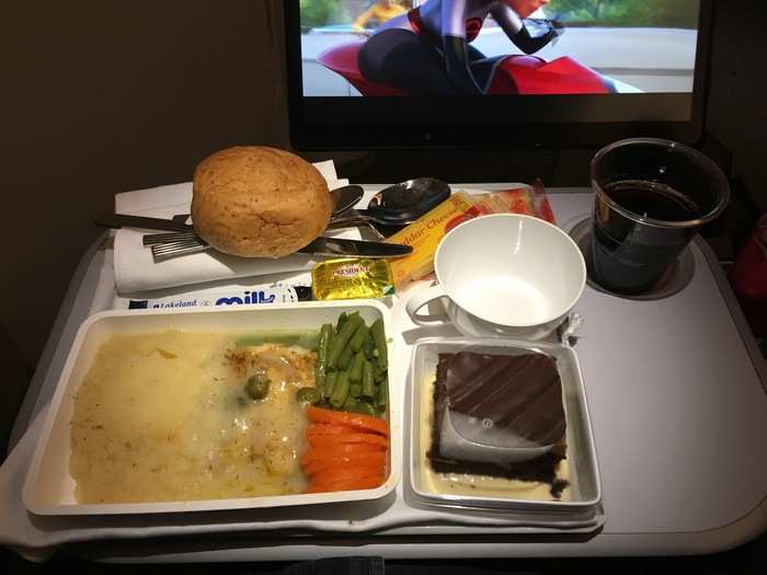 Meal presentation was also decidedly less fancy. Meals are served in a single course on traditional airplane food trays. No fine china here. Again, meals include western cuisine like this baked fish filet as well as...