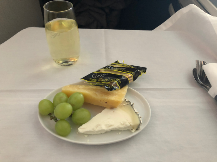 After a short taxi and take-off, we were in the air. Business class meal service began rather quickly after take-off with a light cheese course, and a full drink cart.