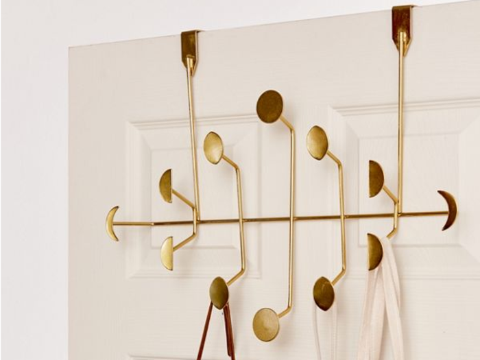 An over-the-door hook that can function in the bathroom or closet for extra storage