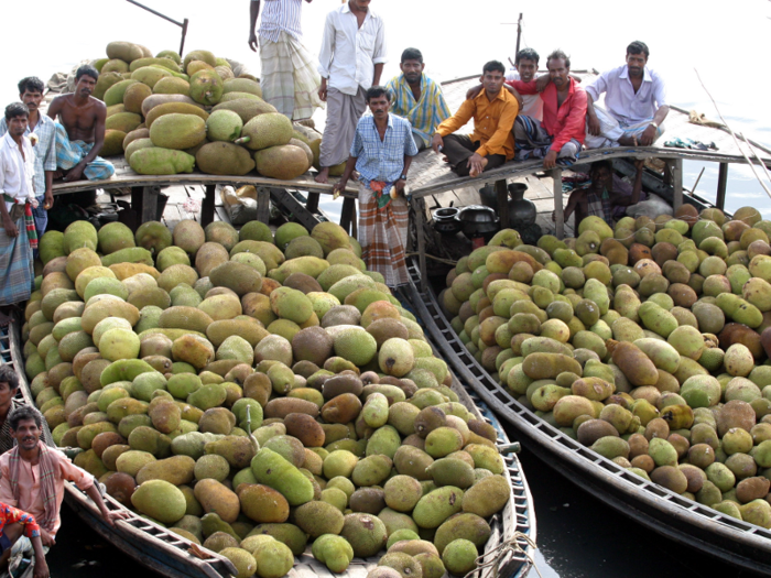 Vendors will pull up in boats along the Buriganga river to wait on the riverbank for potential buyers of goods like jackfruits.