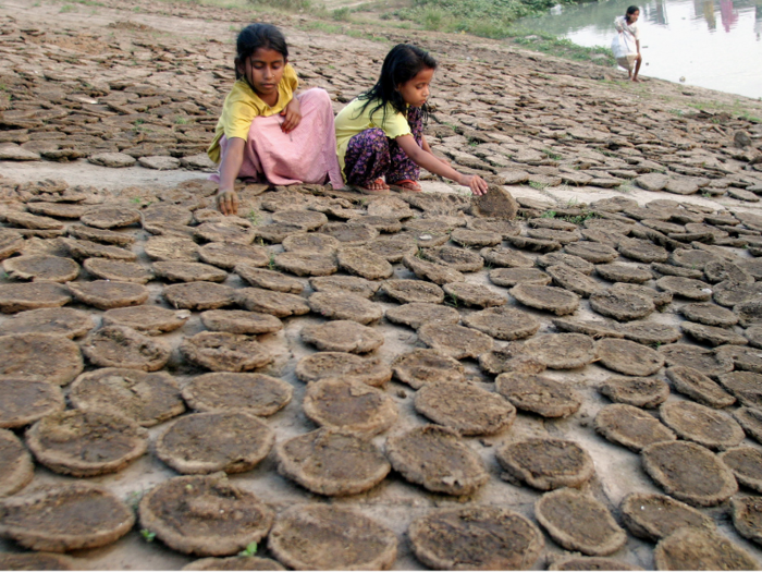 People in the slums of Dhaka will create cakes of cow dung to use as a source of fuel for cooking, or to sell to markets.