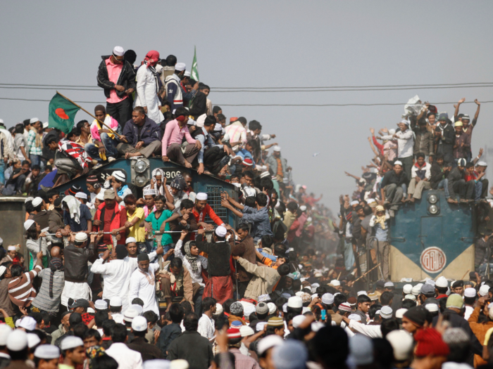 There are no seats inside the trains and many commuters risk hanging off the side or climb 12 feet to sit on the roof of the train.