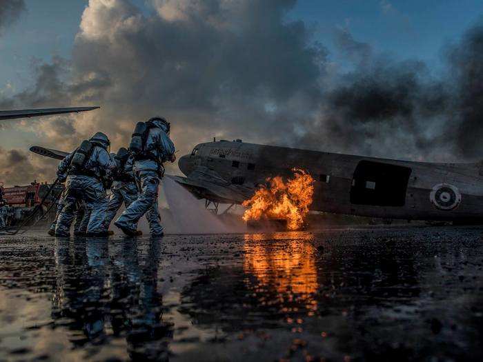 US Marine firefighters and Royal Thai firefighters work together to put out a simulated aircraft fire during Exercise Cobra Gold 2018.