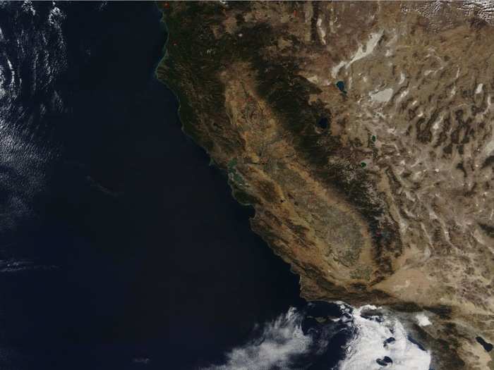 On Thursday, dry, warm winds — including gusts of about 50 mph — blew through northern California. Climate change is drying out more vegetation in the region, increasing the risk that spreading embers will grow into larger blazes.