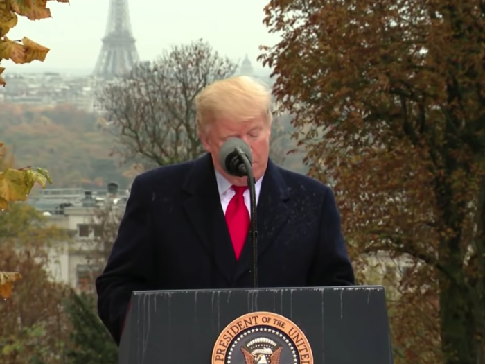 Trump speaks "in soaking rain" at a WWI commemoration ceremony at Suresnes American Cemetery on Sunday.