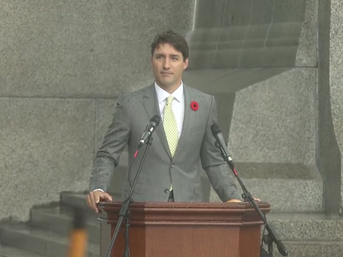 Trudeau then put down the umbrella and said, "As we sit here in the rain, thinking how uncomfortable we must be these minutes as our suits get wet and our hair gets wet and our shoes get wet, I think it