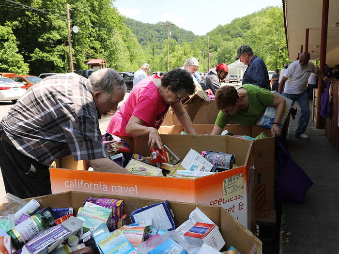 Organizations work to alleviate another major expense by offering free or discounted groceries and household supplies. Food banks, like the one below, are a resource in areas known as "food deserts," where residents live without easy access to fresh, healthy food, including fruits and vegetables.