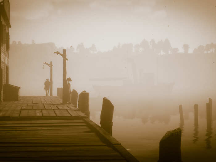 A boat passes by two strangers on the pier.