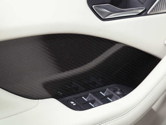 The carbon fiber accents offer a striking contrast to the rich leather upholstery.