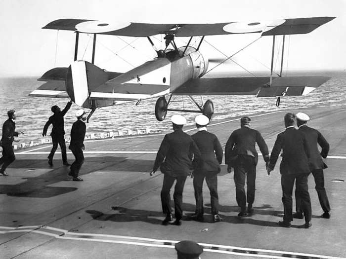 British Royal Naval Air Service pilot Edwin H. Dunning successfully landed an aircraft on a moving warship, the HMS Furious, for the first time on August 2, 1917. He died five days later on a follow-up attempt, demonstrating the challenge of landing on a ship at sea.