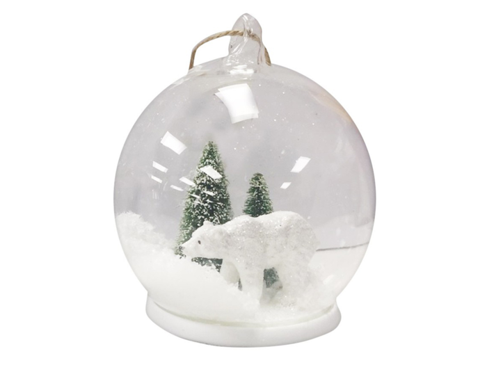 An ornament with a winter wonderland landscape