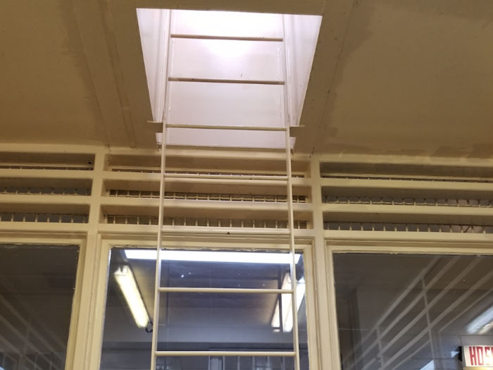 In the secured control room of the holding area, this ladder led up to the roof in the event of a dangerous riot and the guards needed to escape, according to Cohn.