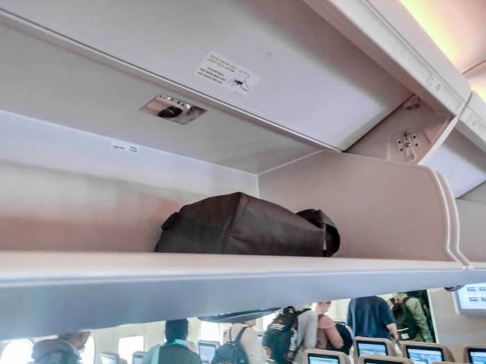 The overhead cabin space is positively massive. I was able to get my fairly large carry-on suitcase (22.7” x 14.7” x 9.6”) in there along with my backpack.