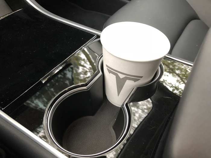 A pair of cupholders and a piano-black center console.