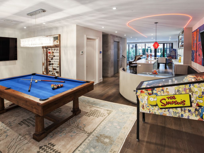 A luxury townhouse in New York City with heated floors and a game room that includes a beer tap, pinball machine, and pool table.