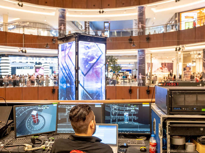 A technician controls the installation from a control booth upstairs.