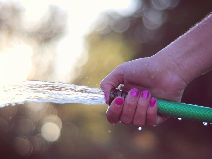 You hose down your driveway or patio instead of sweeping it.